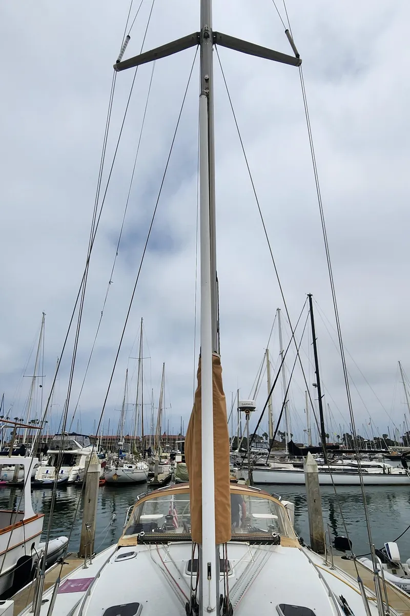 Slide: The Image of 1995 Catalina 42 MkII sailboat docked in a marina, surrounded by other boats. - 47