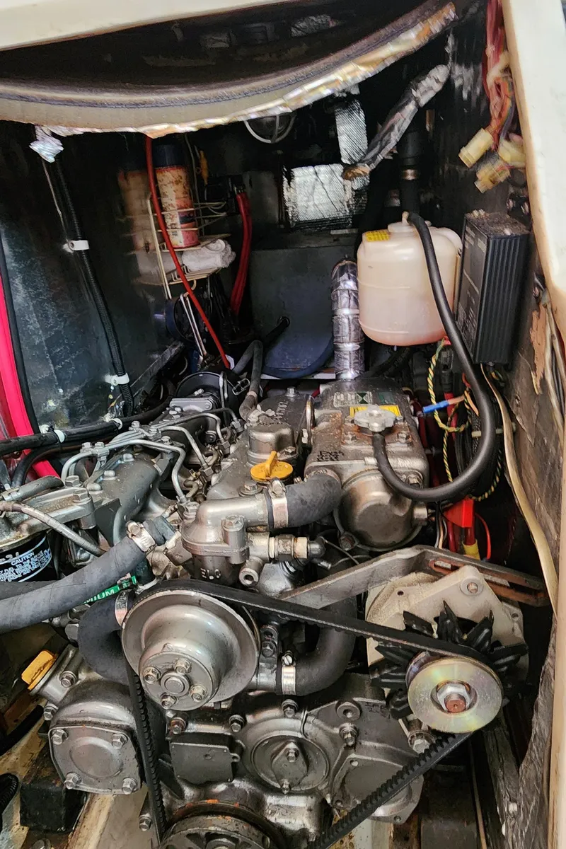 Slide: The Image of Engine compartment of a 1995 Catalina 42 MkII sailboat, showcasing mechanical components. - 49