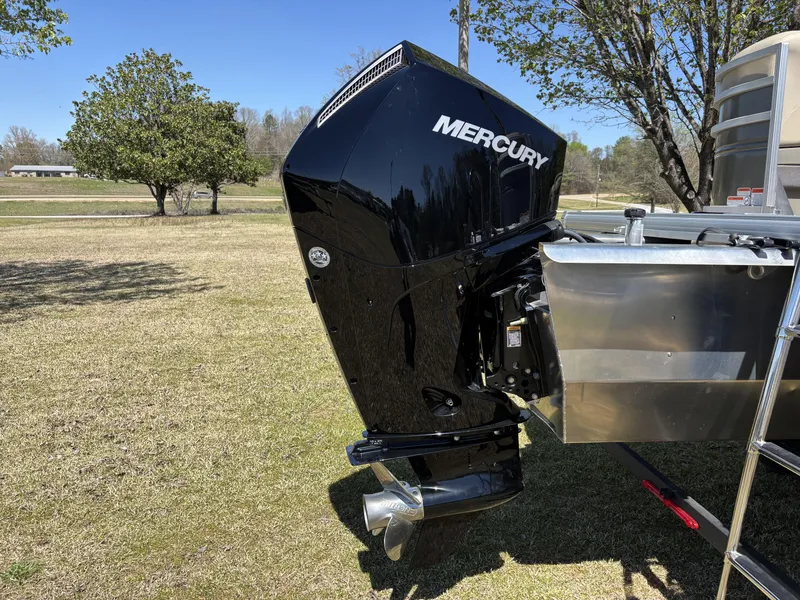 Slide: The Image of 2024 Sun Tracker Party Barge 22 XP3 with Mercury outboard engine on grassy field. - 10