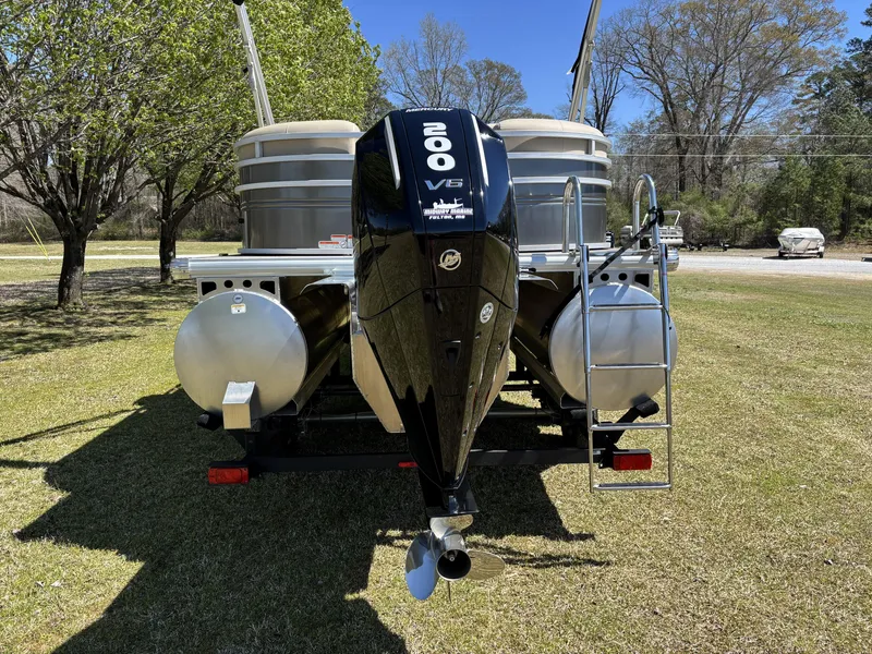 Slide: The Image of 2024 Sun Tracker Party Barge 22 XP3 with powerful 200 V6 engine, parked on grass. - 11