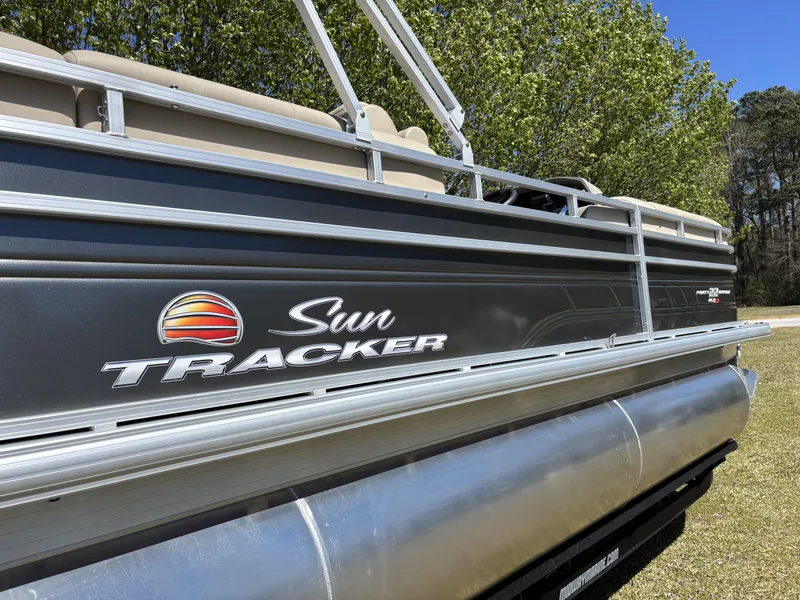 Slide: The Image of 2024 Sun Tracker Party Barge 22 XP3 pontoon boat, side view with logo and railing. - 12