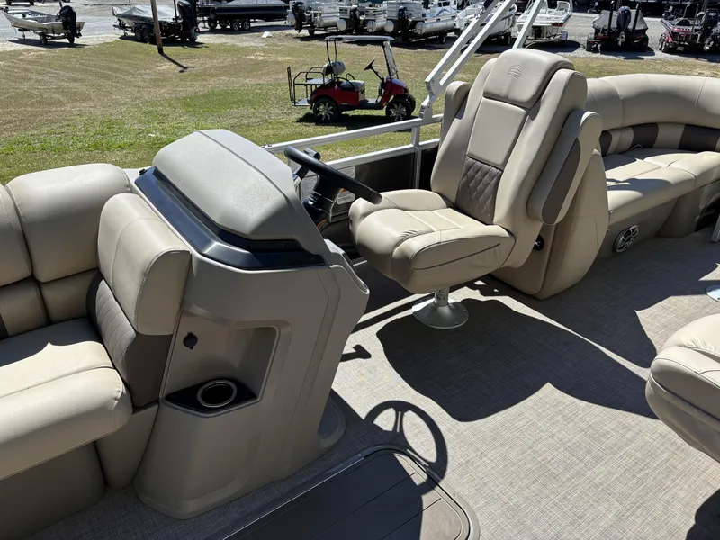 Slide: The Image of 2024 Sun Tracker Party Barge 22 XP3 interior with beige seating and steering console. - 5