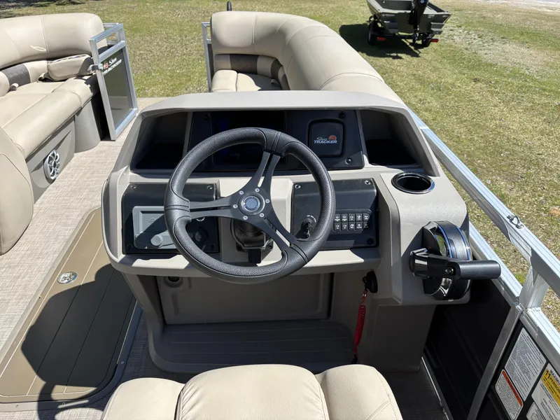 Slide: The Image of 2024 Sun Tracker Party Barge 22 XP3 helm with steering wheel and controls. - 8