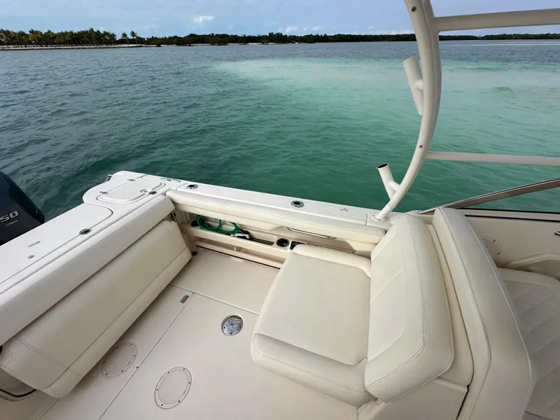 Slide: The Image of 2018 Grady-White Freedom 275 boat interior with seating, overlooking calm waters. - 11