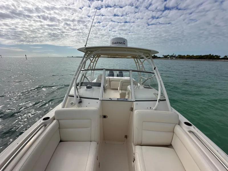 Slide: The Image of 2018 Grady-White Freedom 275 boat on open water under cloudy sky. - 14