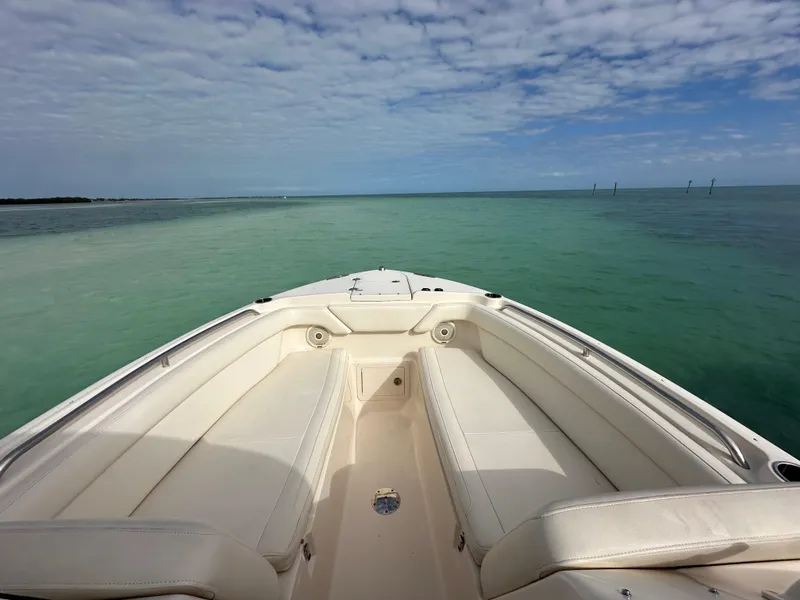 Slide: The Image of 2018 Grady-White Freedom 275 boat on calm turquoise waters under a partly cloudy sky. - 20