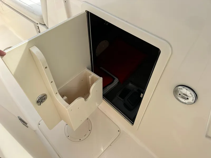 Slide: The Image of 2018 Grady-White Freedom 275 boat storage compartment with open hatch and interior view. - 23