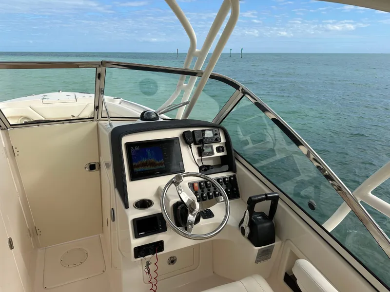 Slide: The Image of 2018 Grady-White Freedom 275 boat dashboard with ocean view. - 27