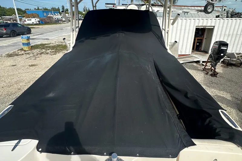 Slide: The Image of 2018 Grady-White Freedom 275 boat covered with a black tarp in a yard. - 35