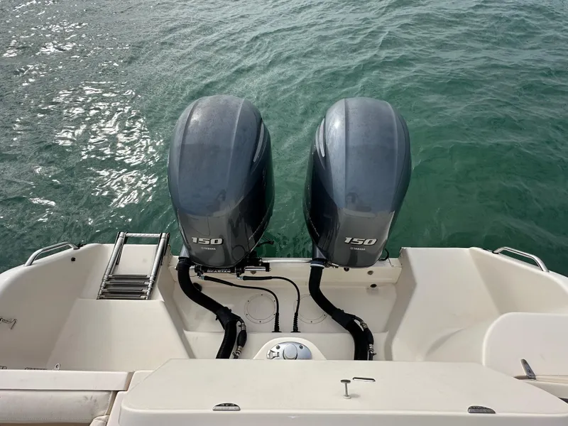 Slide: The Image of 2018 Grady-White Freedom 275 boat with twin 150 horsepower outboard engines on water. - 5