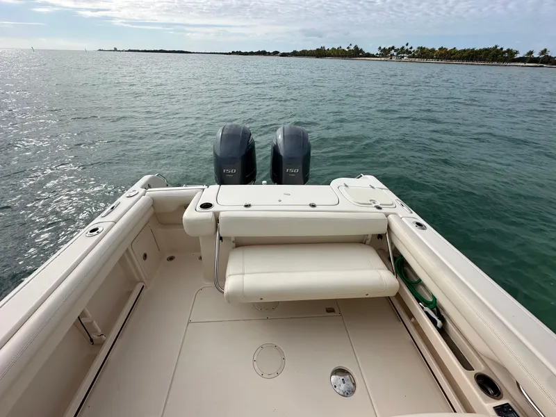 Slide: The Image of 2018 Grady-White Freedom 275 boat with dual engines on open water. - 6