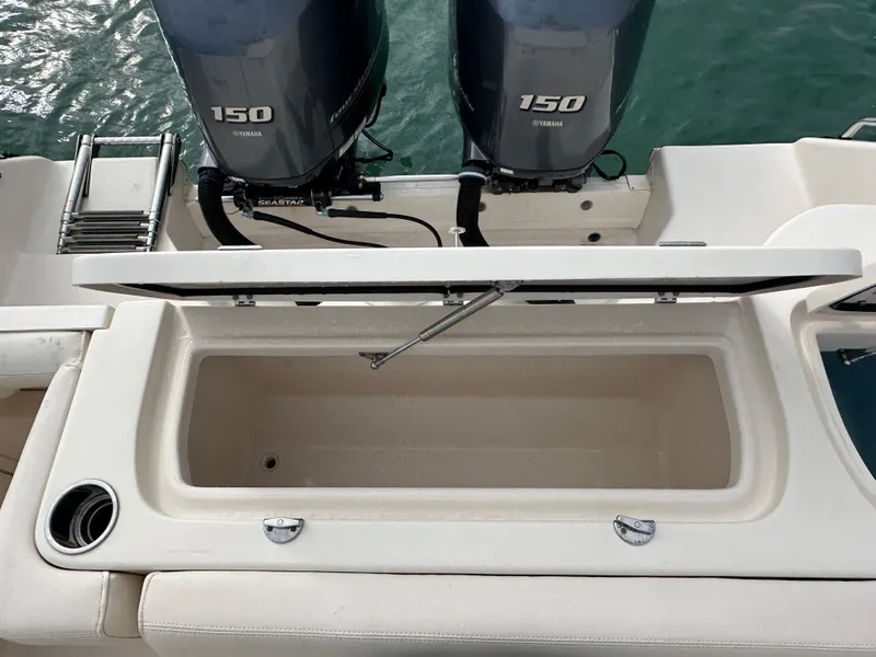 Slide: The Image of 2018 Grady-White Freedom 275 boat with dual 150 Yamaha engines and open storage compartment. - 8