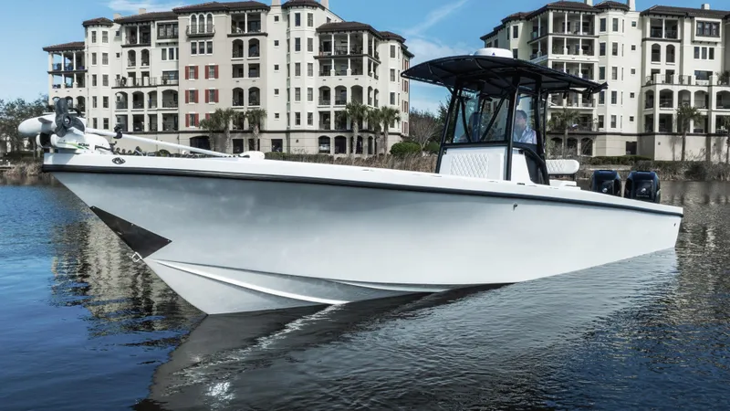 Slide: The Image of Privateer 2800 SEA PROWLER 2001 boat on water, with luxury buildings in background. - 1