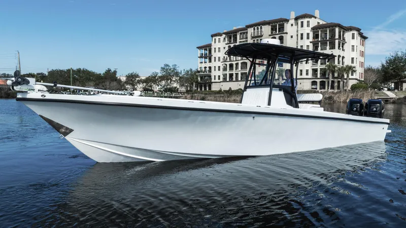 Slide: The Image of 2001 Privateer 2800 SEA PROWLER boat on water, with building in background. - 2