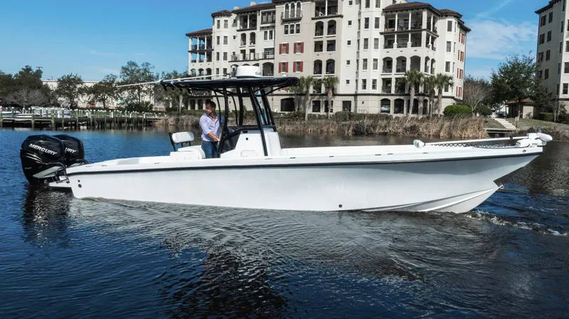 Slide: The Image of 2001 Privateer 2800 SEA PROWLER boat cruising near waterfront buildings. - 4