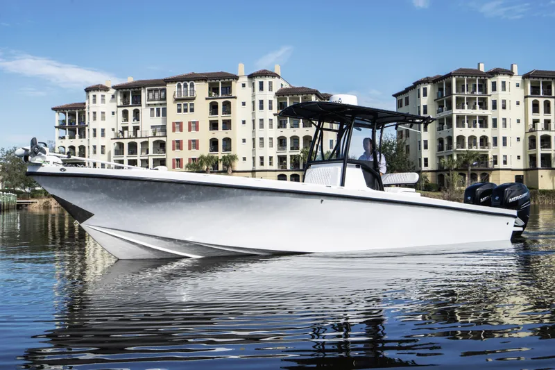 Slide: The Image of 2001 Privateer 2800 SEA PROWLER boat on water, with buildings in the background. - 5