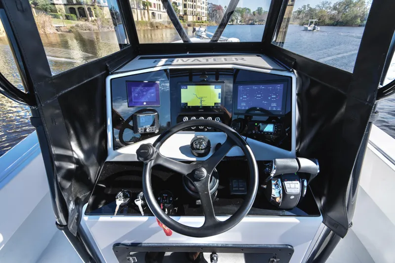 Slide: The Image of Control panel of 2001 Privateer 2800 SEA PROWLER boat with navigation screens and steering wheel. - 7