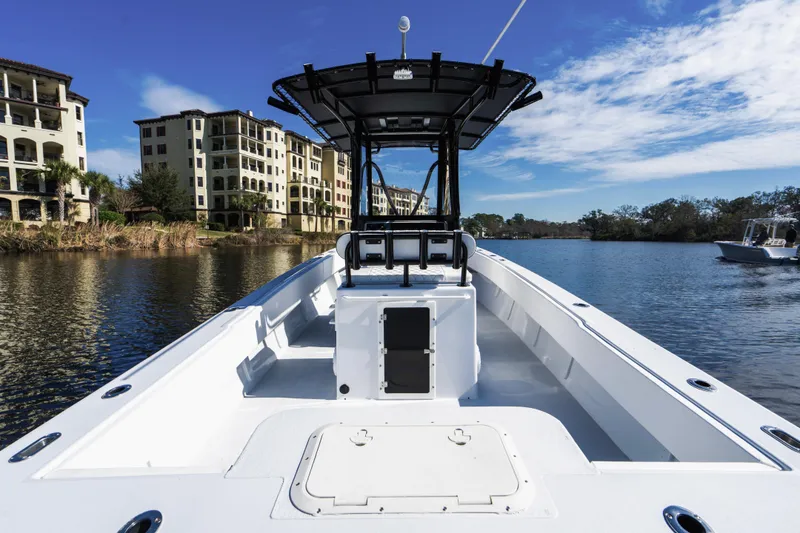 Slide: The Image of 2001 Privateer 2800 SEA PROWLER boat on calm water near luxury buildings. - 8