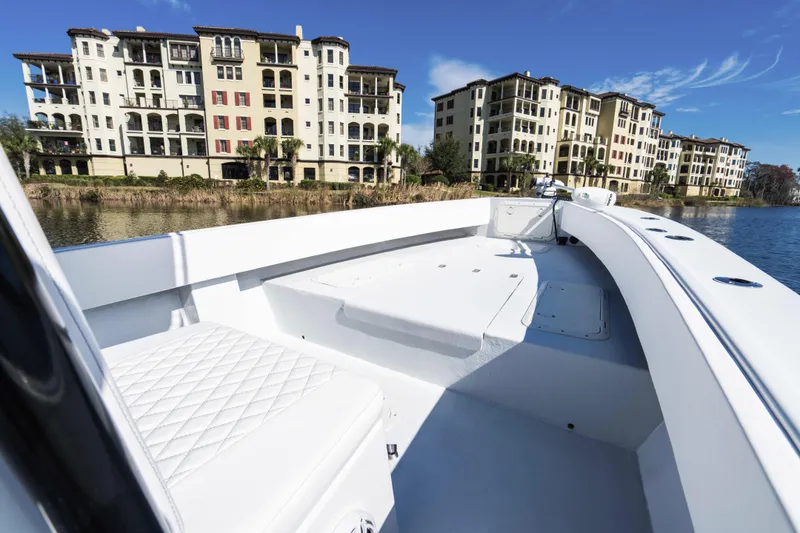 Slide: The Image of 2001 Privateer 2800 SEA PROWLER boat on water near luxury apartments, clear sky. - 9