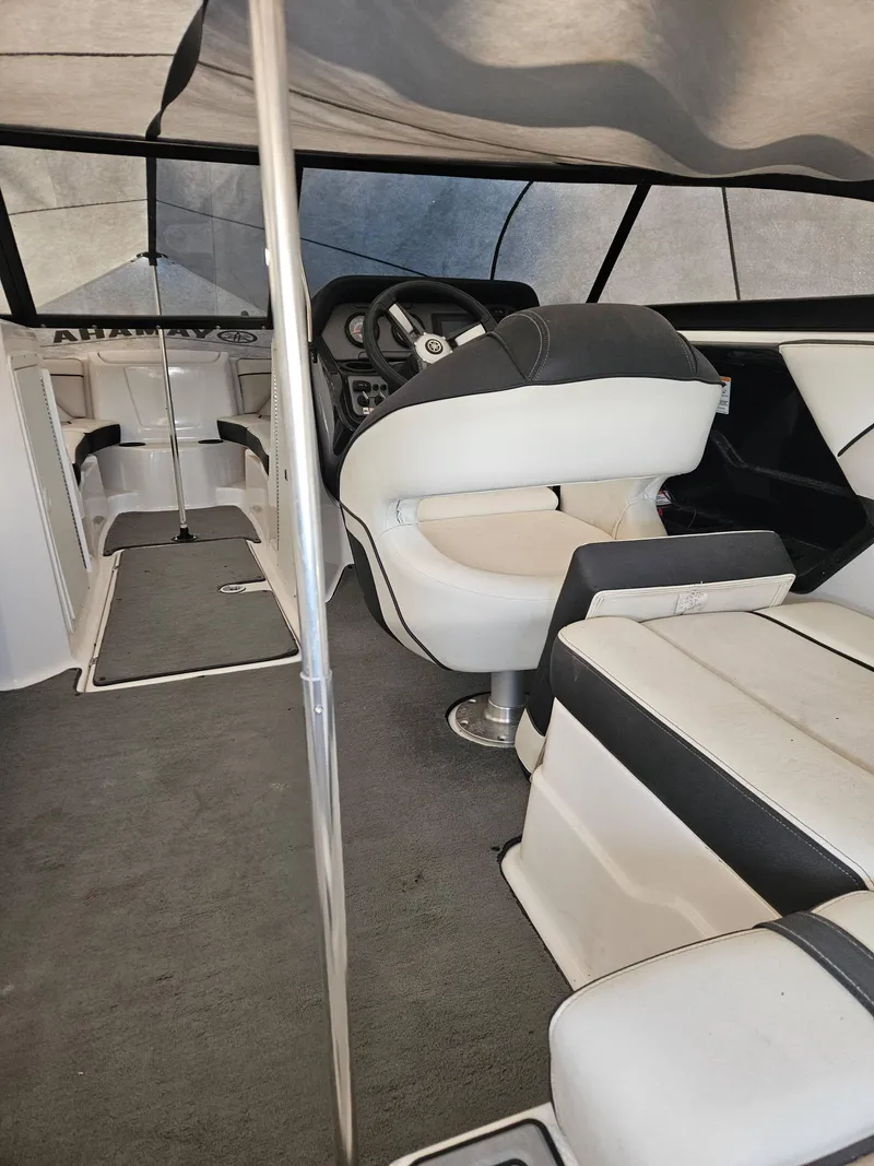 Slide: The Image of Interior of a 2017 Yamaha Boats SX210, featuring seating and steering area. - 10