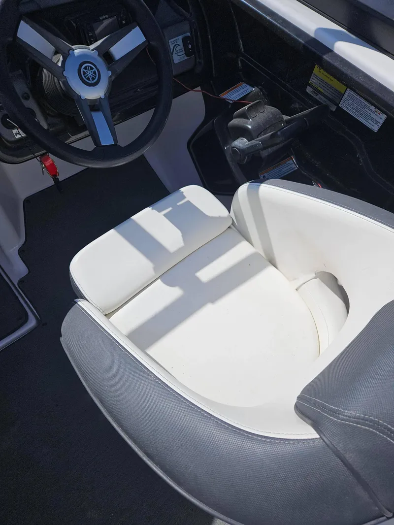 Slide: The Image of 2017 Yamaha Boats SX210 cockpit with steering wheel and cushioned seat. - 4