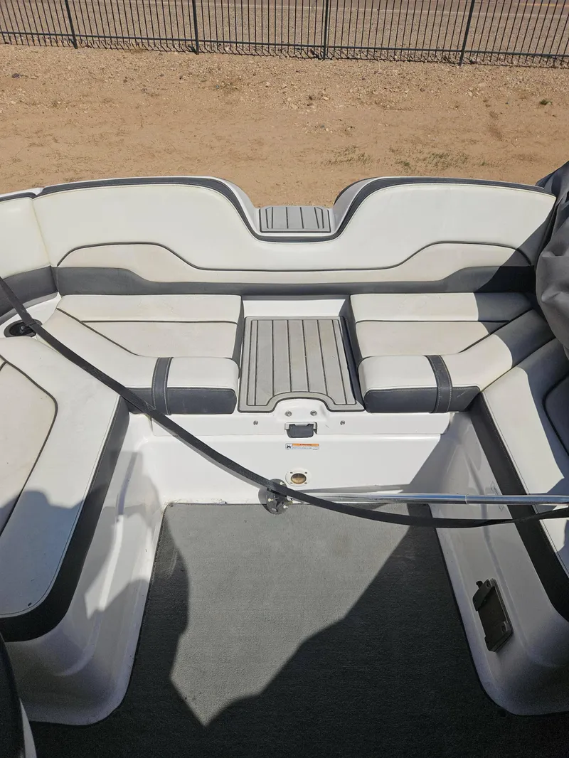 Slide: The Image of 2017 Yamaha Boats SX210 interior seating area with cushioned seats and deck. - 5