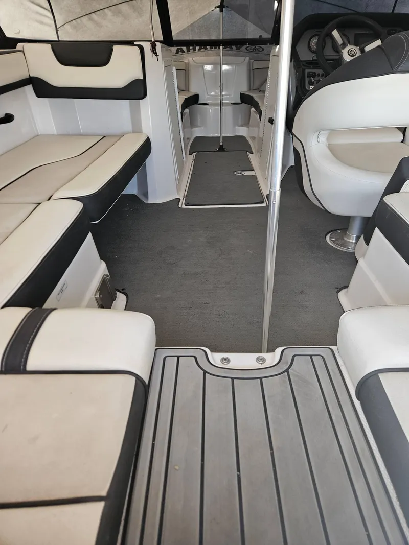 Slide: The Image of Interior of a 2017 Yamaha Boats SX210, featuring seating and steering area. - 9