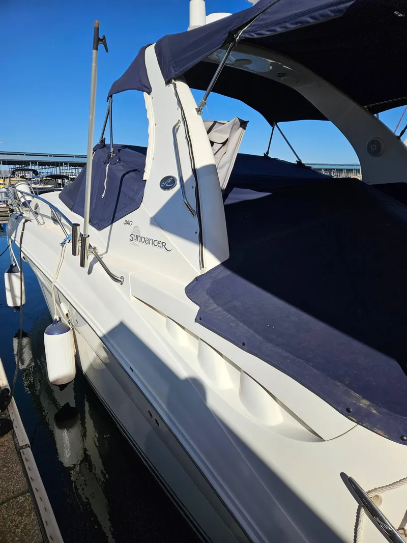 Slide: The Image of 2005 Sea Ray 320 DA Sundancer yacht docked at marina, featuring blue canopy. - 4