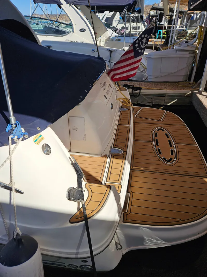 Slide: The Image of 2005 Sea Ray 320 DA boat with American flag, docked with teak swim platform. - 5