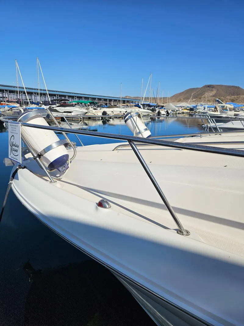 Slide: The Image of 2005 Sea Ray 320 DA yacht docked in a marina with clear blue skies. - 6