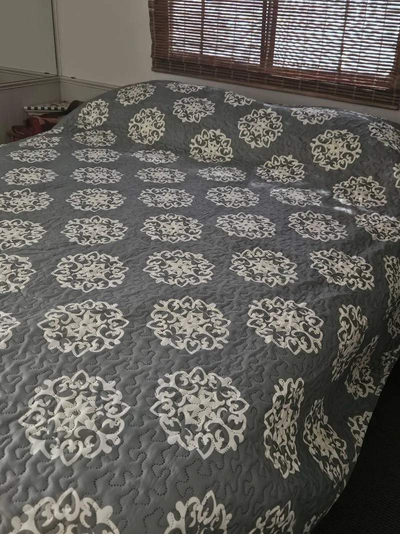 Slide: The Image of Gray patterned bedspread in a Skipperliner 1990 houseboat bedroom. - 12