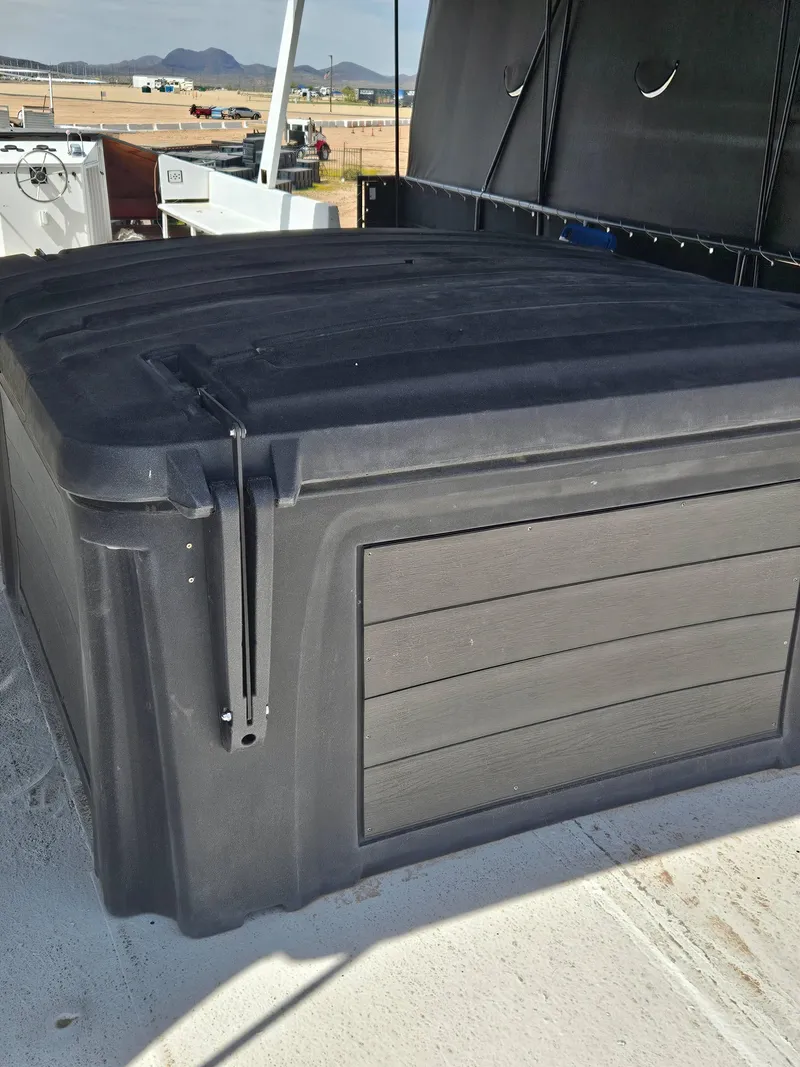 Slide: The Image of Black storage box on 1990 Skipperliner houseboat deck, with distant mountains in background. - 15