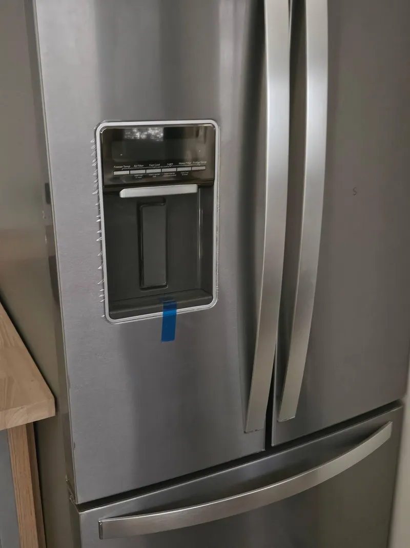 Slide: The Image of Stainless steel refrigerator with water dispenser and double doors. - 5