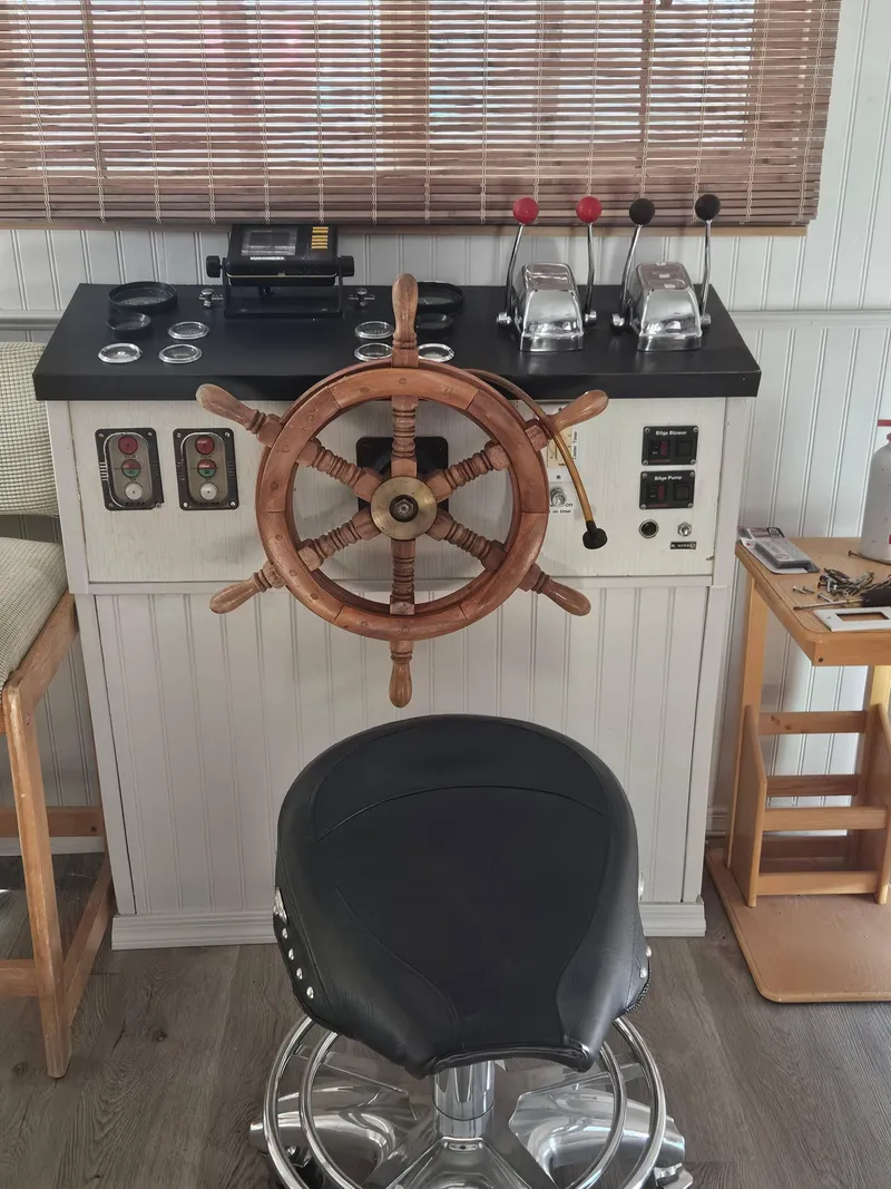 Slide: The Image of 1990 Skipperliner houseboat helm with wooden wheel and control panel. - 7