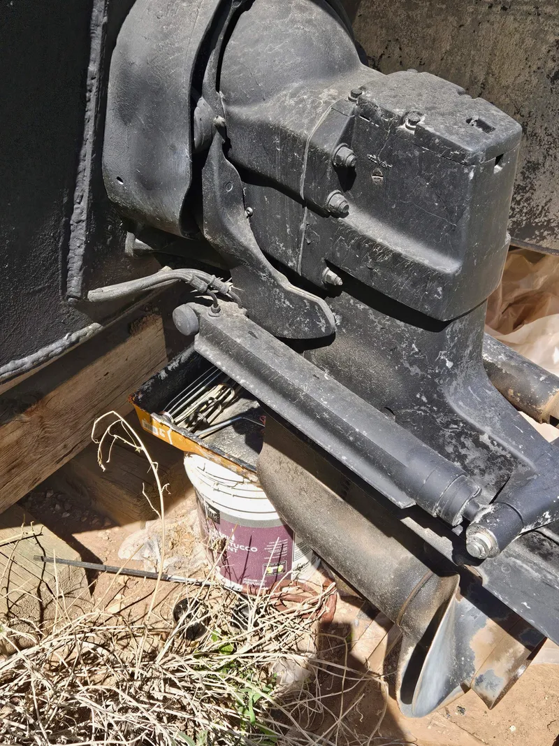 Slide: The Image of Close-up of a 1990 Skipperliner houseboat engine component, showing wear and outdoor setting. - 9