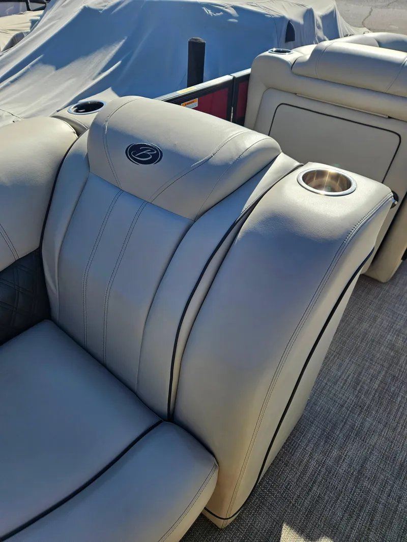 Slide: The Image of 2019 Barletta L21Q Pontoon boat seat with cup holders and logo detail. - 10