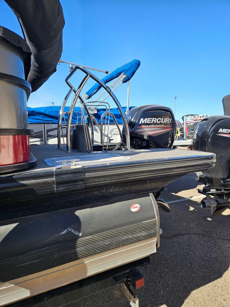 Slide: The Image of 2019 Barletta L21Q Pontoon with Mercury outboard motor, docked under clear blue sky. - 13
