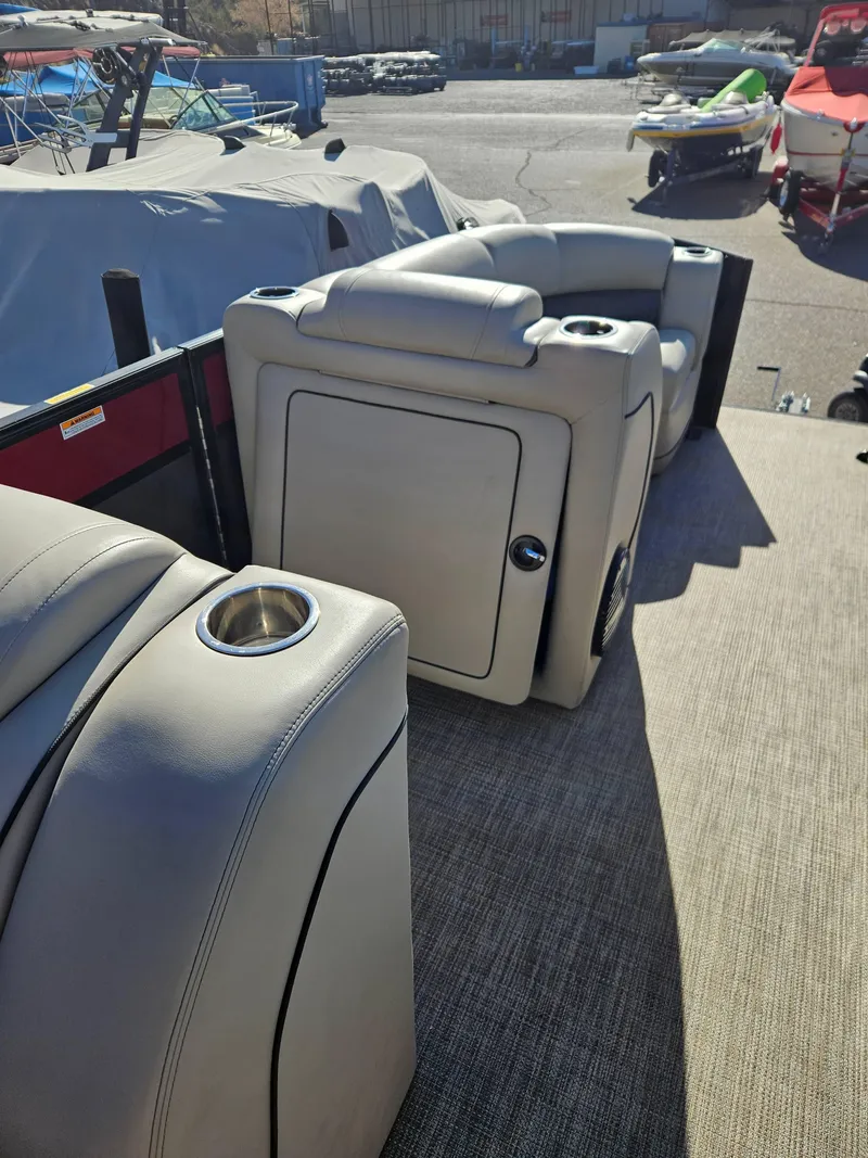 Slide: The Image of 2019 Barletta L21Q Pontoon interior with beige seating and cup holders. - 14