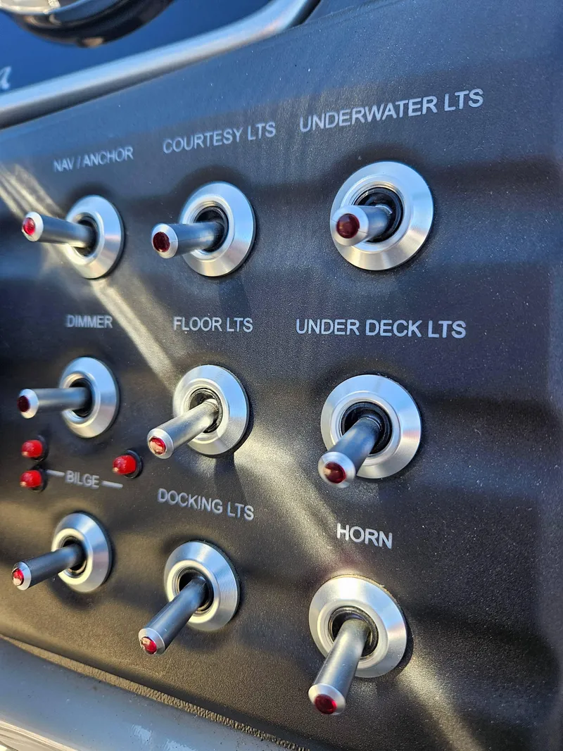 Slide: The Image of Control panel of 2019 Barletta L21Q Pontoon with labeled switches for various functions. - 15