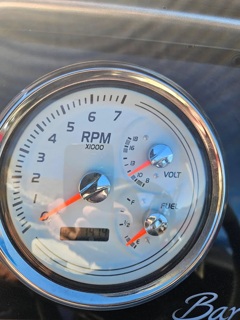 Slide: The Image of Close-up of 2019 Barletta L21Q Pontoon dashboard gauges showing RPM, voltage, and fuel levels. - 18