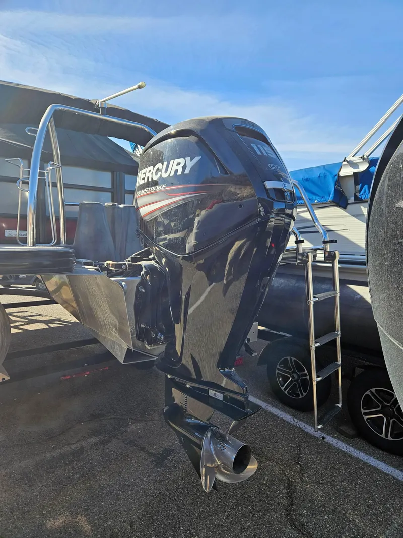 Slide: The Image of 2019 Barletta L21Q Pontoon with Mercury outboard motor, parked on a trailer. - 4