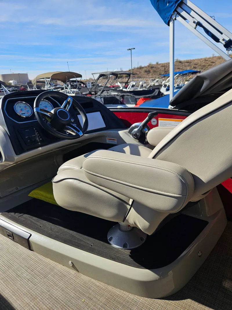 Slide: The Image of 2019 Barletta L21Q Pontoon boat interior with steering wheel and captain's chair. - 7