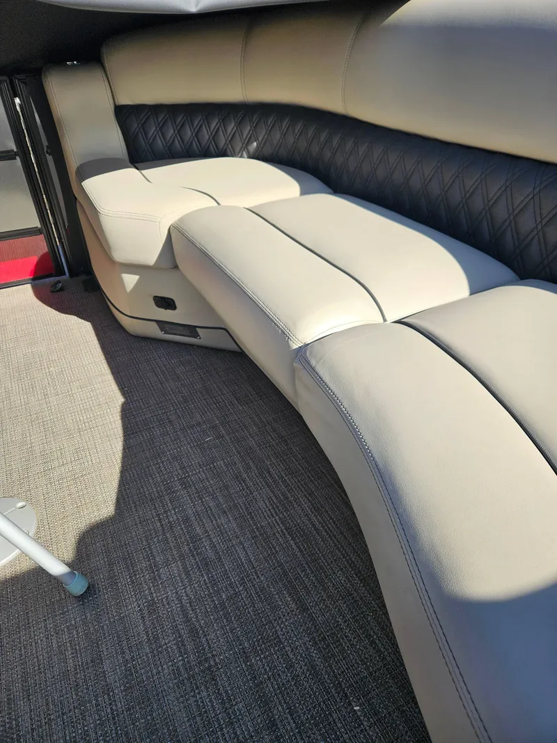 Slide: The Image of 2019 Barletta L21Q Pontoon interior with beige seating and carpet flooring. - 9
