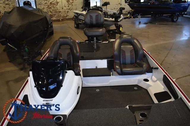 Slide: The Image of 2019 Nitro Z18 boat interior with seating and steering console in showroom. - 15