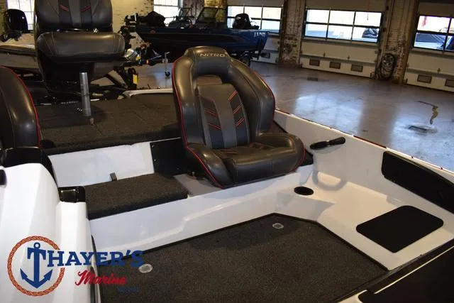 Slide: The Image of Interior of a 2019 Nitro Z18 boat with seating and carpeted flooring. - 16