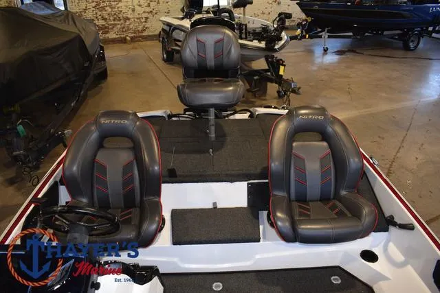 Slide: The Image of 2019 Nitro Z18 boat interior with three seats in a showroom. - 17