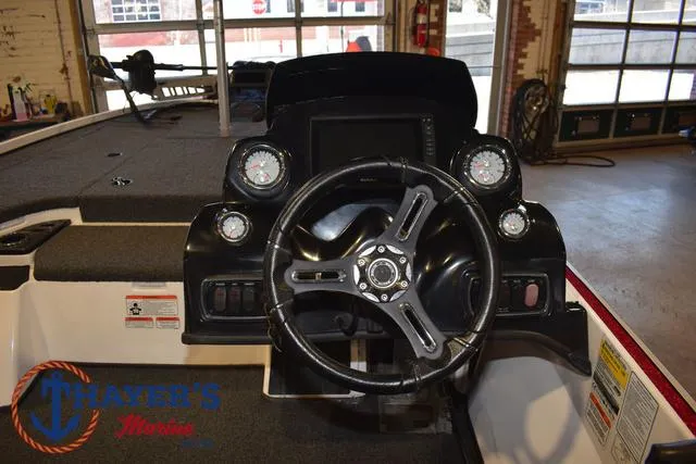 Slide: The Image of 2019 Nitro Z18 boat dashboard with steering wheel and gauges in a showroom. - 21