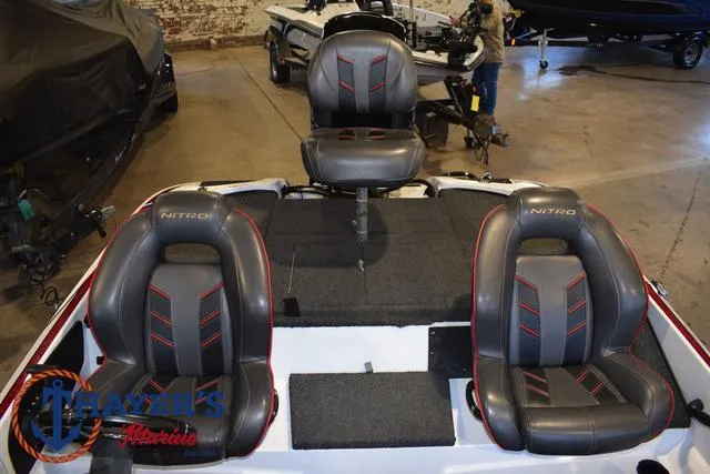 Slide: The Image of 2019 Nitro Z18 boat interior with three gray seats in a showroom. - 25