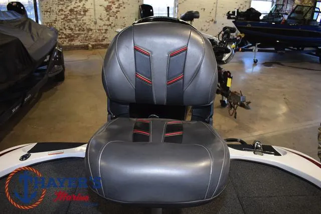 Slide: The Image of 2019 Nitro Z18 boat seat with black and red accents in a showroom. - 29