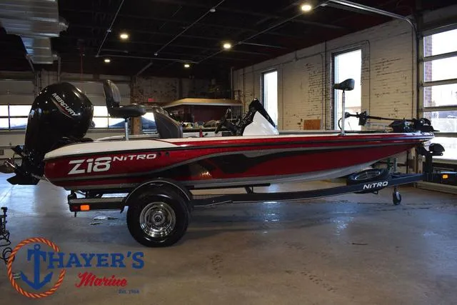 Slide: The Image of 2019 Nitro Z18 boat in showroom, red and white design, Thayer's Marine logo visible. - 3